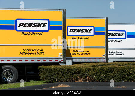 A logo sign and rental trucks outside of a facility occupied by Penske Truck Leasing in Reading, Pennsylvania, on April 22, 2018. Stock Photo