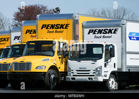 A logo sign and rental trucks outside of a facility occupied by Penske Truck Leasing in Reading, Pennsylvania, on April 22, 2018. Stock Photo