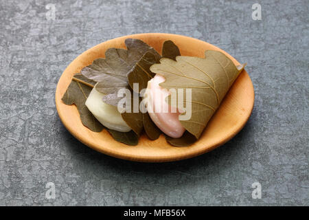 kashiwa mochi is white mochi surrounding a sweet anko filling with a kashiwa oak leaf wrapped around it. Stock Photo