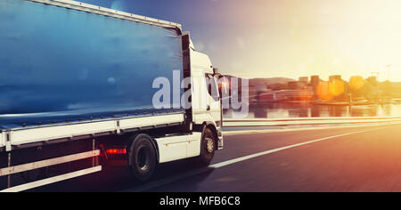 Truck run fast on the highway to deliver Stock Photo