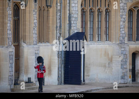 A Guard inside Windsor Castle, marches from his sentry box in the Quadrangle at the foot of the Round Tower's motte. Stock Photo