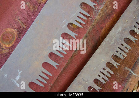 Two old crosscut saw blades look ornate in their design when photographed close up. Stock Photo