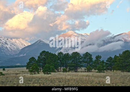 Mount White, a fourteen thousand foot mountain in the Collegiate Peaks Range near Nathrop, Colorado, glows with color as the sun rises across the vall Stock Photo