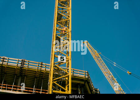 Two cranes at construction site Stock Photo