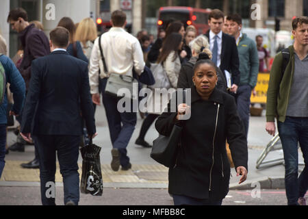 Office workers and commuters walking to work during the morning rush hour in the City of London Stock Photo