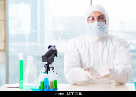 Young chemist student working in lab on chemicals Stock Photo