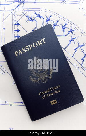 Used United States Passport rests on a background sketch of planes at a terminal. Stock Photo