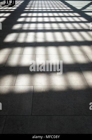 Lights and shadows on tiled floor by sunny day Stock Photo