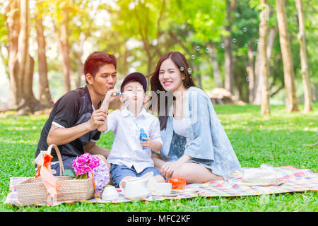 Asian teen family happy holiday picnic moment in the park Stock Photo