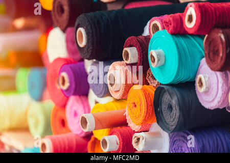 Thread rolls in a textile industry. Range of colours Stock Photo - Alamy