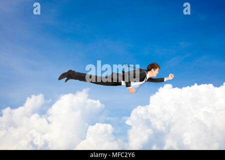 business man flying above the cloud Stock Photo