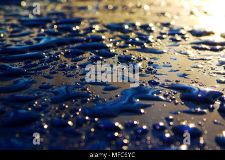 drops of water-repellent surface in black & blue and sun Stock Photo