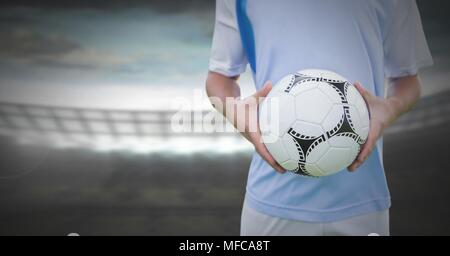 Soccer player on grass with football in stadium Stock Photo