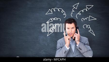 Stressed businessman on phones with arrow doodles on blackboard Stock Photo