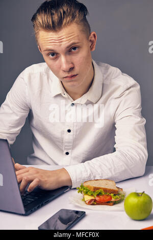 man while lunch at the office looking at camera Stock Photo