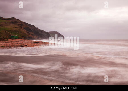 Sunrise on Charmouth beach looking towards Golden Cap. Stock Photo