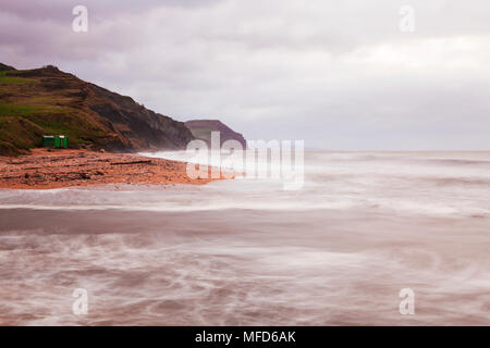 Sunrise on Charmouth beach looking towards Golden Cap. Stock Photo