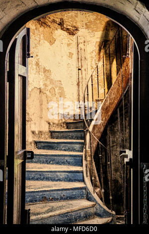 A composite image showing the view through a doorway to a mysterious shadow descending a derelict staircase. Stock Photo