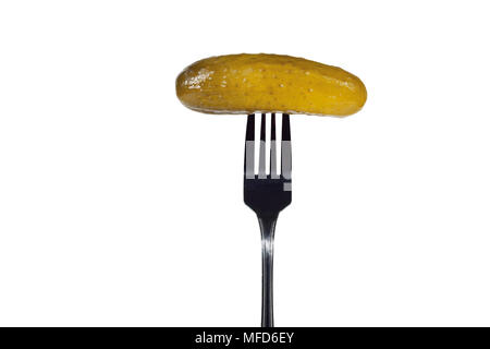 Salted cucumber on a fork. Isolated on white background. Stock Photo