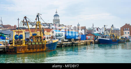 Fishing trawlers 'Morning Star' and 'Providing Star'  moored against the harbour wall in Portsmouth, UK. Stock Photo