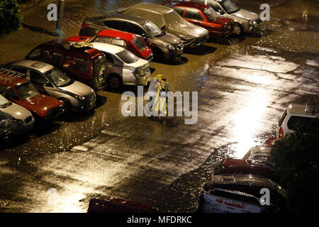 Cairo, Egypt. 25th Apr, 2018. Pedestrians walk in the rain in Cairo, Egypt, on April 25, 2018. Several parts of Cairo and Giza witnessed heavy rainfall with lightning and thunder on Wednesday. Credit: Ahmed Gomaa/Xinhua/Alamy Live News Stock Photo