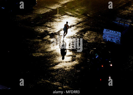 Cairo, Egypt. 25th Apr, 2018. A pedestrian walks in the rain in Cairo, Egypt, on April 25, 2018. Several parts of Cairo and Giza witnessed heavy rainfall with lightning and thunder on Wednesday. Credit: Ahmed Gomaa/Xinhua/Alamy Live News Stock Photo