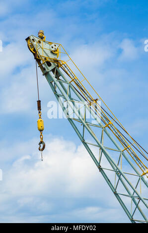 Close up view of the end of a crane against a blue sky. Stock Photo