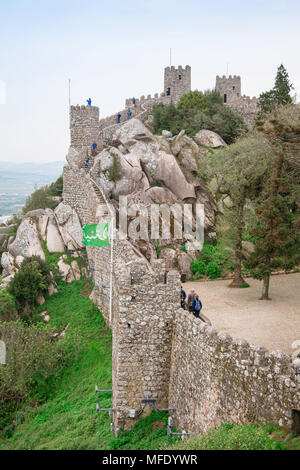 Sintra castle, view of tourists exploring the castle walls of the Castelo dos Mouros (Castle Of The Moors), Sintra, Portugal. Stock Photo