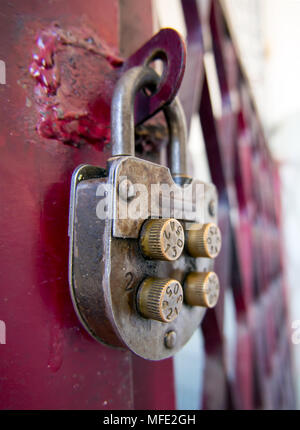 Vintage mechanical combination lock hanging on doors Stock Photo