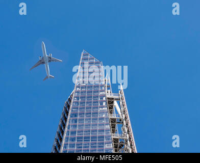 Airplane close to the top of the Shard, London, UK Stock Photo