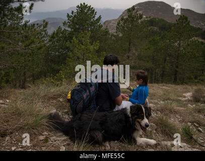rest father and son walking in the mountains of Montenegro with a dog Stock Photo