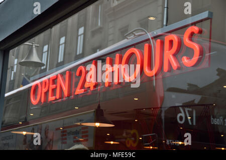 Open 24 hours sign outside a restaurant bar. Stock Photo