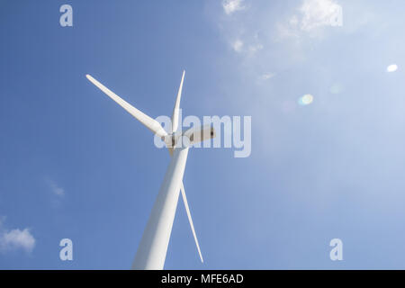 low angle view of wind turbine against partly cloudy blue sky Stock Photo