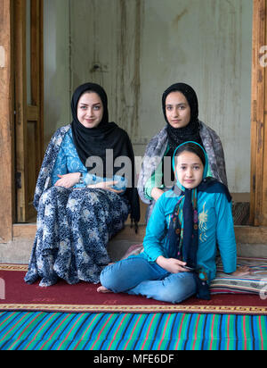 Kang, Iran - July 30, 2016 : portrait of three iranian sisters wearing colorful traditional clothes Stock Photo