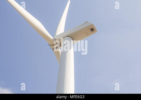 low angle view of wind turbine against partly cloudy blue sky Stock Photo