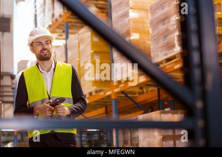 Positive nice man looking at the boxes Stock Photo