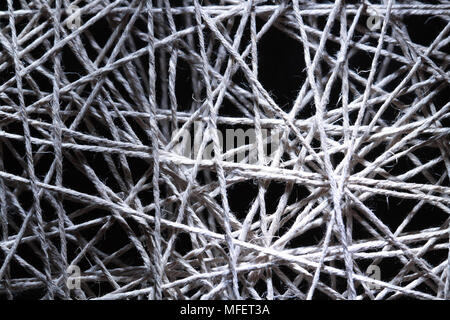 Background made from gray crossing rope on dark Stock Photo