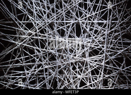 Background made from gray crossing rope on dark Stock Photo