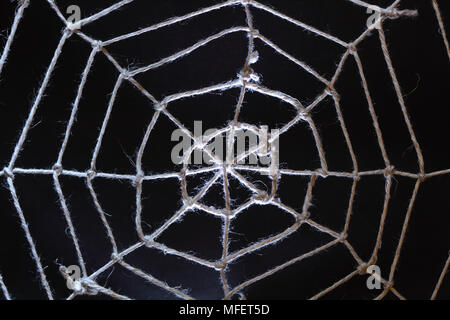Conceptual background with web made from rope on dark Stock Photo