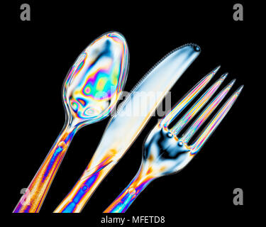 Cross polarization showing stress within plastic utensils. Stock Photo