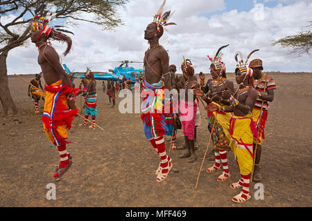 Rendille men in traditional dress dancing. Rendille people are a tribe that inhabit Northern Kenya. They are nomads who tend camels, sheep, goats and Stock Photo