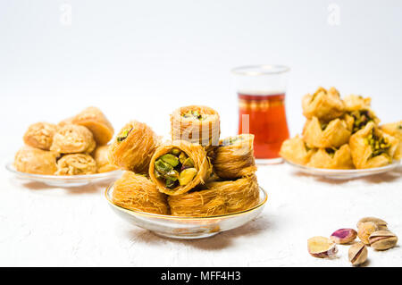 Various Arabic desserts with pistachio on plates Stock Photo
