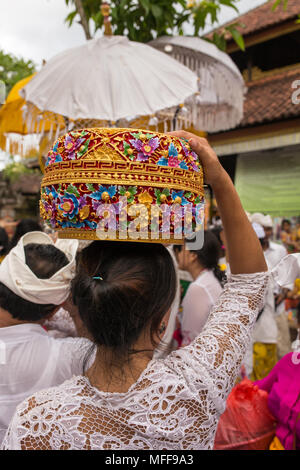 Bali, Indonesia - September 17, 2016: Unidentified balinese woman with religious offering during Galungan celebration in Bali. Stock Photo