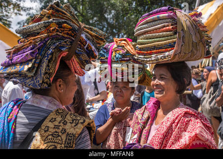 Bali, Indonesia - August 20, 2016: Balinese vendors selling sarongs during public cremation in Ubud, Bali, Indonesia. Stock Photo