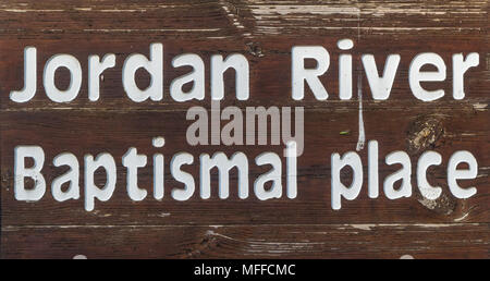 Wooden sign on shore of Jordan River at Baptismal Site, Israel Stock Photo