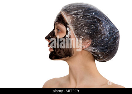 Woman profile portrait with black peel-off mask on face isolated on white backdrop. Skin beauty and care theme. Stock Photo