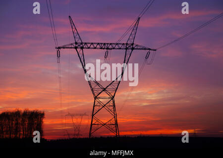 Energy pole silhouette on dramatic sky. Energetic tower on sunrise. Stock Photo