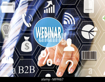The businessman clicks WEBINAR button on the touch screen Stock Photo