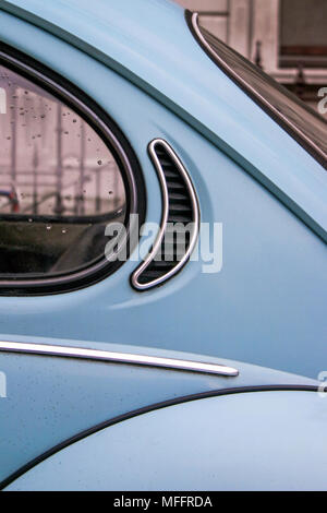 A detail close up of a vintage blue VW beetle / bug on a London street, shows curves and lines of the classic design, almost abstract still life. Stock Photo