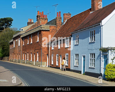 Woman walking along street in Woodbridge, Essex, England UK Stock Photo